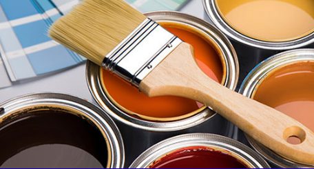 Open cans of paint with a brush